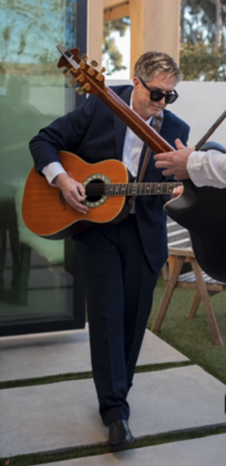 Dan Martin, CFE, playing acoustic guitar
