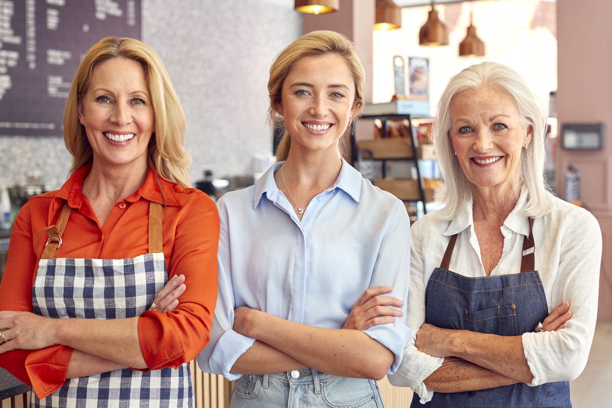 Franchise business owners and staff standing together in their store